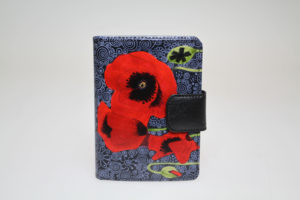 The Red Poppy in front of Black Tapestry