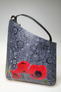 The Red Poppy in front of Black Tapestry