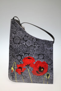 The Red Poppy in front of black Tapestry