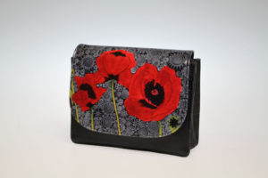 The Red Poppy in front of black Tapestry